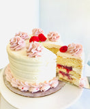 “THE WINNER! 🏆 “The Sadie” sweet Vanilla Cake with Raspberry Filling, Raspberry Swirl Italian Buttercream topped with Fresh Raspberries and a Mint Leaf!